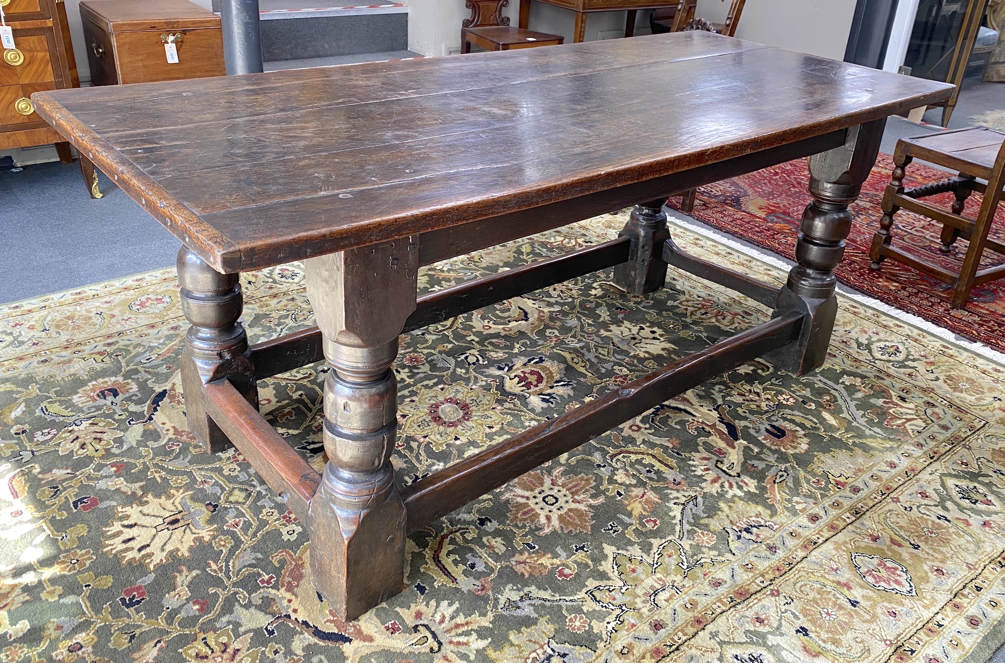 An 18th century and later rectangular oak refectory dining table, length 194cm, width 83cm, height 79cm and two Derbyshire style oak chairs